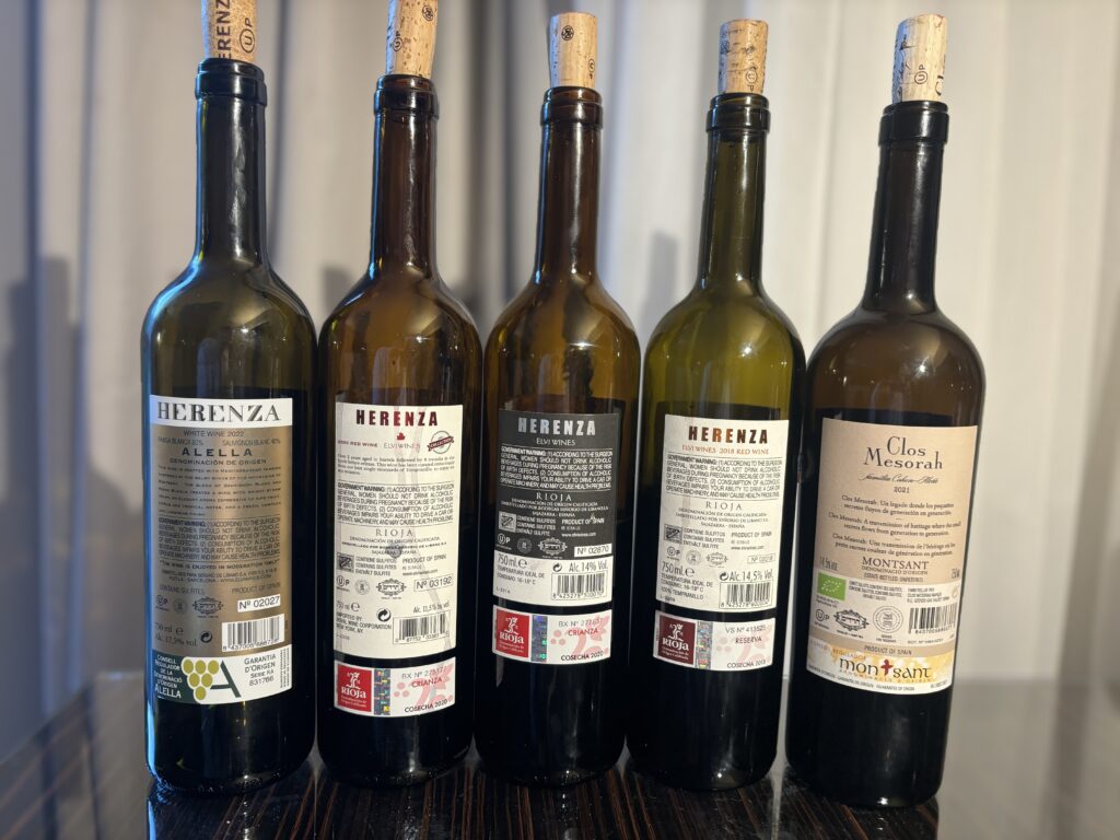 2022 Elvi Wines, Herenza, White, Alella (back label); 2020 Elvi Wines, Herenza, Rioja, Crianza, Collection (back label); 2020 Elvi Wines, Herenza, Rioja, Crianza (back label); 2018 Elvi Wines, Herenza, Rioja, Reserva (back label); 2021 Elvi Wines, Clos Mesorah, Montsant (back label);